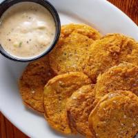 Fried Green Tomatatoes · Fried cornmeal crusted green tomatoes served with honey creole remoulade