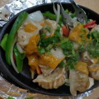 Sizzler Momo · Another palatable authentic traditional dish from nepal serve with sizzling (steamed or frie...
