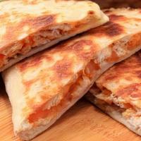 Chicken Quesadilla · Sauteed chicken breast and cheese all melted together in a flour tortilla. Served with a sid...
