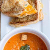 Bowl Roasted Tomato Soup · Garnished with house made walnut pesto and croutons. Vegan. Add a 3-cheese grilled cheese sa...