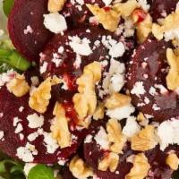 Spinach And Beet · Spinach and romaine, beets, and roasted walnuts with a pomegranate vinaigrette and topped wi...