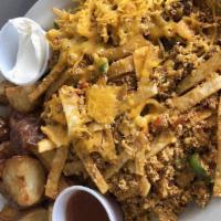 Migas · 4 scrambled eggs with corn tortilla strips, tomato, onion, bell peppers, and cheese served w...