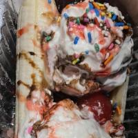 #23 Banana Split · Vegetarian. Three scoops of ice cream (vanilla, chocolate, and strawberry) served between th...