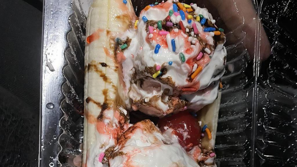 Banana Split · Vegetarian. Three scoops of ice cream (vanilla, chocolate, and strawberry) served between the split banana. Chocolate syrup drizzled on top, and whipped cream (optional), then topped with sprinkles and maraschino cherry.
