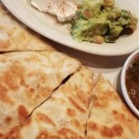 Quesadillas · Flour tortilla with Monterrey cheese sautéed onions, mushrooms and your choice of beef or ch...