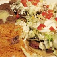 Sopes · Homemade dish corn masa deep fried topped with refried beans, sour cream, queso fresco and y...