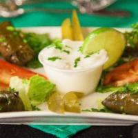 Dolmas · Hand rolled grape leaves, stuffed with rice, tomatoes, onions and parsley marinated with lem...