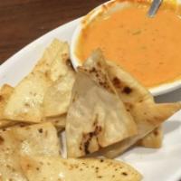 Chile Con Queso · Served with flour tortilla chips.