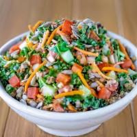 Quinoa Salad · With mixed greens, olives, almonds,  raisins, tahini dressing, feta