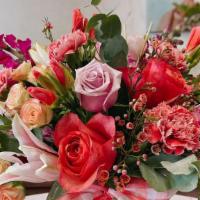 Dozen Rose And Mixed Flower  · A large arrangement in a glass vase with a dozen roses in mixed colors with addtional season...