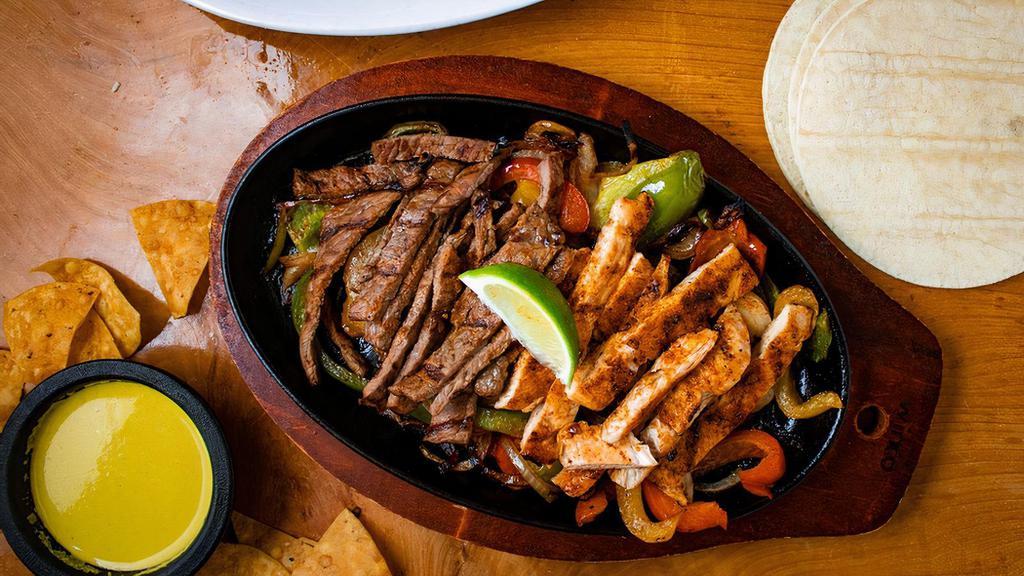 Fajitas · Choice of grilled chicken or beef served with grilled bell peppers and onions. Comes with a side of rice and refried beans, sour cream, Guacamole , pico, Shredded cheese, and
tortillas.