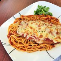 Chicken Parmigiana · Tender juicy breaded chicken cooked in marinara sauce, served over a bed of soft pasta. Topp...