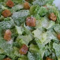 Caesar Salad · Crisp romaine lettuce, shaved parmesan cheese and croutons tossed in Caesar dressing and ser...
