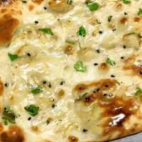 Butter Naan · Fresh tandoor- baked white flour bread. Served with a touch of butter.