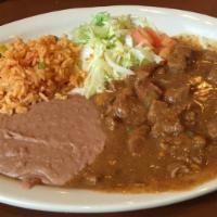 Carne Guisada Plate · Served with rice beans, lettuce, and tomatoes.