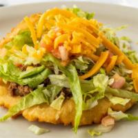 Puffy Tacos Plate · Two puffy tacos of beef or chicken served with rice, beans, lettuce, and tomatoes.