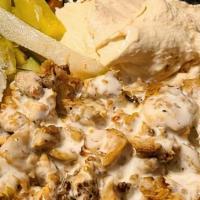 Chicken Gyro Plate · Tender chicken gyro served with basmati rice, side salad, fresh pita and your choice of sauce.