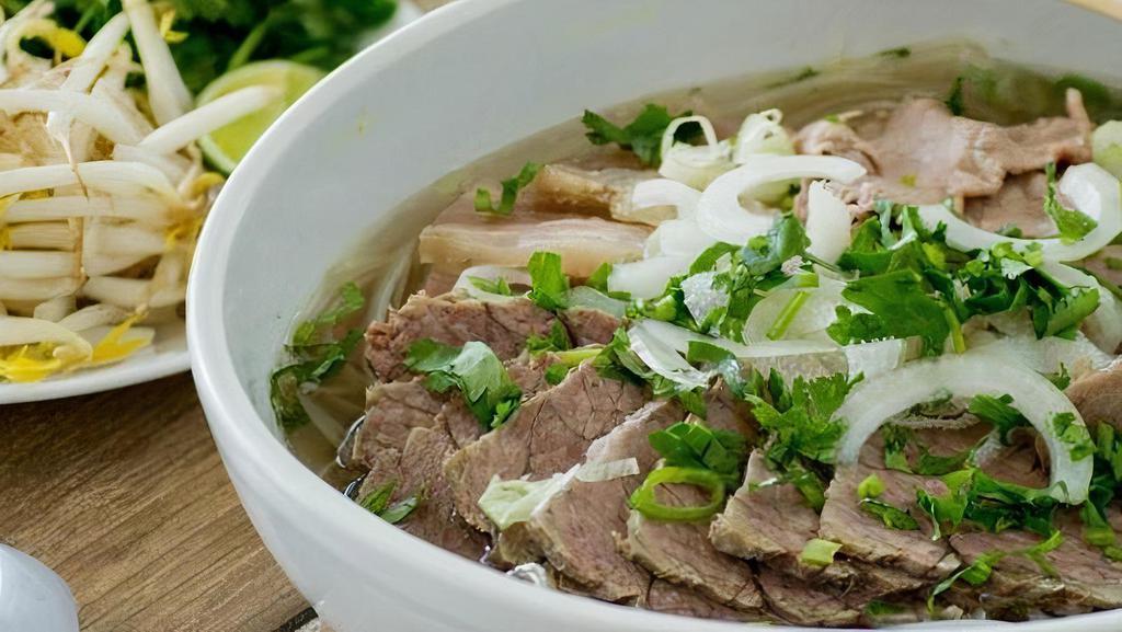16 Combination · Slowly simmered Vietnamese beef broth served with rice noodles, with rare steak, brisket, tendon, and meatballs, served with garnish.