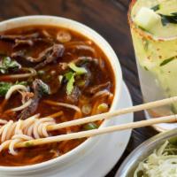 209 Spicy Beef Soup · Spicy soup and thick rice noodles topped with tender beef shank