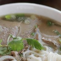 14 Brisket And Tendon · Slowly simmered Vietnamese beef broth served with rice noodles, with brisket and tendon, ser...
