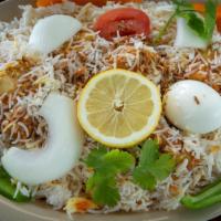 Chicken Dum Biryani · Chicken cooked in basmati rice with special herbs and spices.