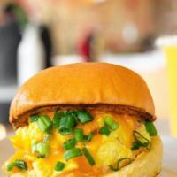 The Scramble · Cage-free soft scrambled eggs, green onions, cheddar, chipotle aioli, on a warm butter-flake...