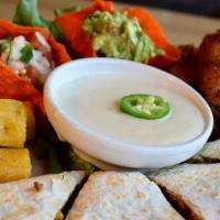 Baja Sampler · Four hand breaded chicken and cheese stuffed jalapeños, four chicken flautas and chicken que...