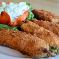 Stuffed Jalapeños · Four hand breaded fresh jalapeños stuffed with shredded chicken and cheese. Fried to a golde...