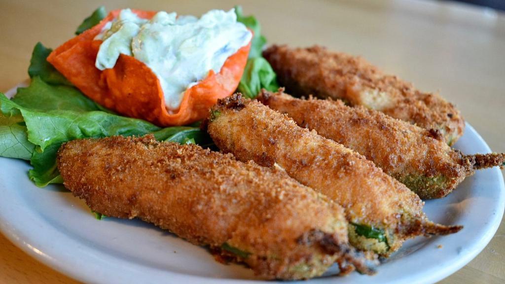 Stuffed Jalapeños · Four hand breaded fresh jalapeños stuffed with shredded chicken and cheese. Fried to a golden brown. Served with our own avocado dip.