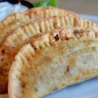 Empanadas · 3 soft dough empanadas filled with seasoned ground beef and cheddar cheese. Deep fried to a ...