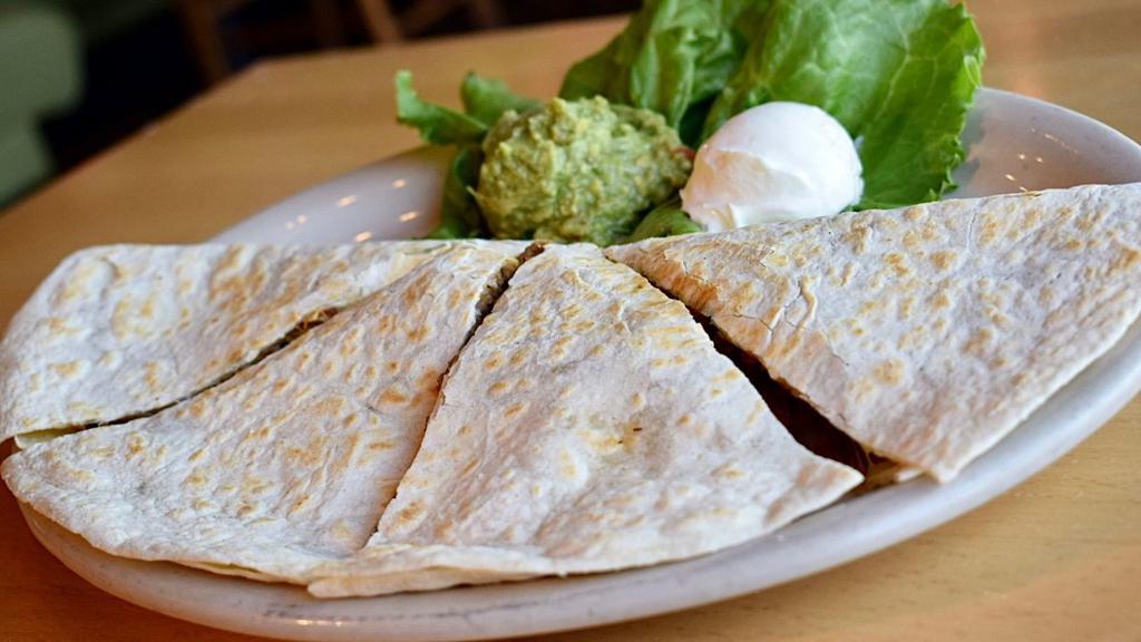 Quesadillas · A large grilled flour tortilla filled with jack cheese, mild pico de gallo and your choice of either seasoned ground beef or shredded chicken. Served with sour cream and guacamole.