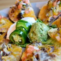 Fajita Nachos · Traditional Nachos topped with refried beans and either fajita steak or chicken, melted chee...