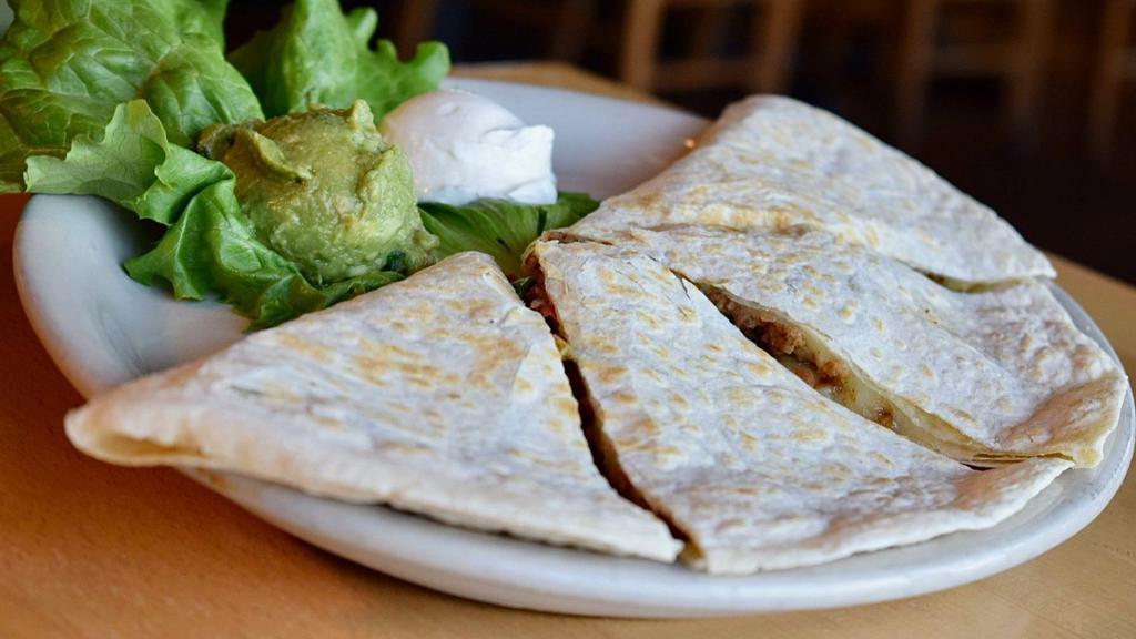 Veggie Quesadillas · A large flour tortilla stuffed with pico de gallo, grilled zucchini, yellow squash, onions, peppers, and jack cheese. Served with sour cream and guacamole.
