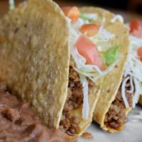 Gringo Tacos · Three crispy tacos filled with seasoned beef or shredded chicken. Topped with lettuce, tomat...