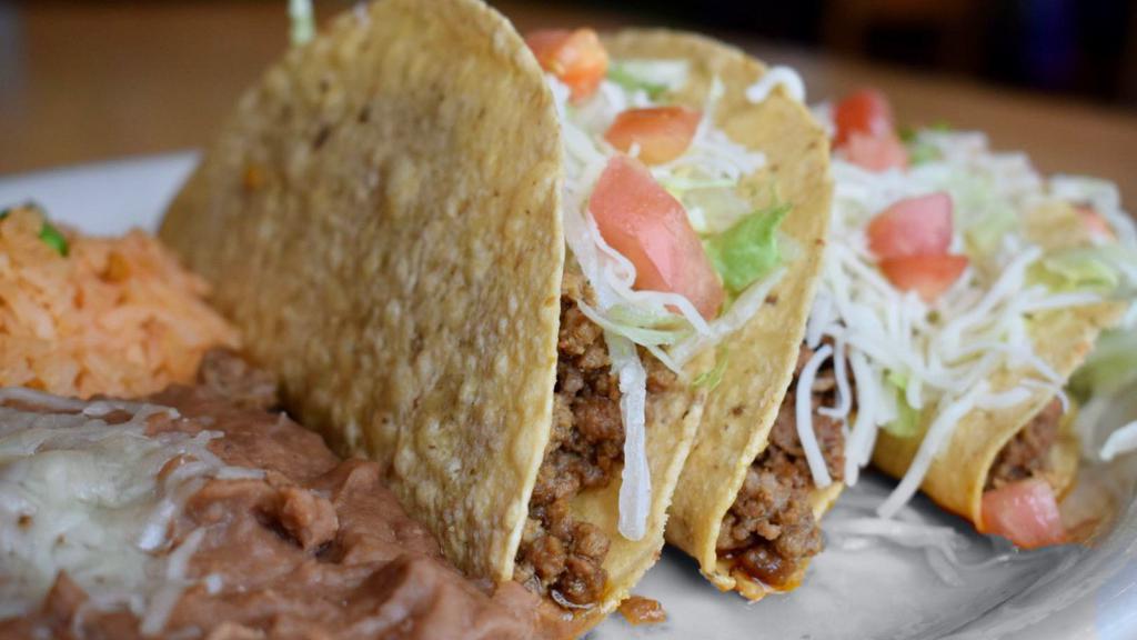 Gringo Tacos · Three crispy tacos filled with seasoned beef or shredded chicken. Topped with lettuce, tomatoes and cheese.