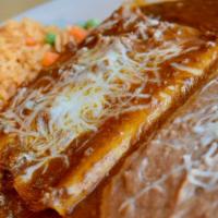 Enchilada Platter · Two hand rolled corn tortillas filled with your choice of seasoned beef, shredded chicken, o...
