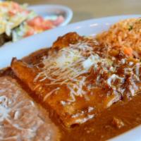 La Paz · Two crispy seasoned ground beef tacos and two hand rolled cheese enchiladas topped with chil...