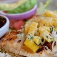 Tilapia Mexicana · Two seasoned grilled tilapia fillets topped with fresh mango salsa and melted Monterrey Jack...