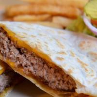 Quesadilla Burger · Mr. Clark’s favorite! A fresh ground beef patty cooked medium with melted cheese inside two ...