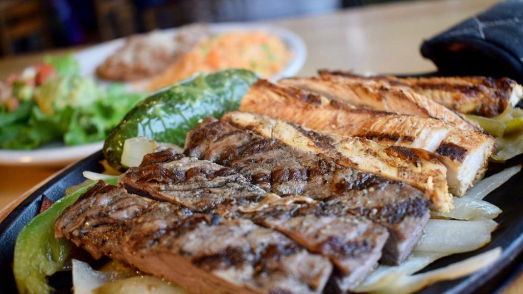 Baja Fajitas · A sizzling skillet of marinated chicken or combination inside skirt steak & chicken, sautéed with fresh bell peppers and onions. Served with charro beans, rice, guacamole, pico de gallo and warm tortillas.
