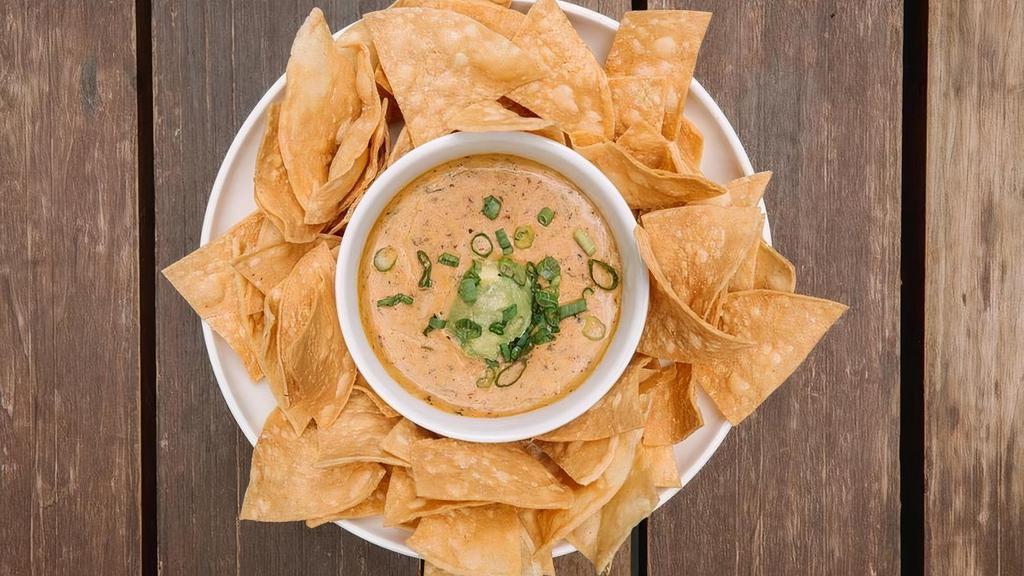 Hg Chips & Queso · spicy vegan queso topped with avocado. & green onion // CONTAINS NUTS