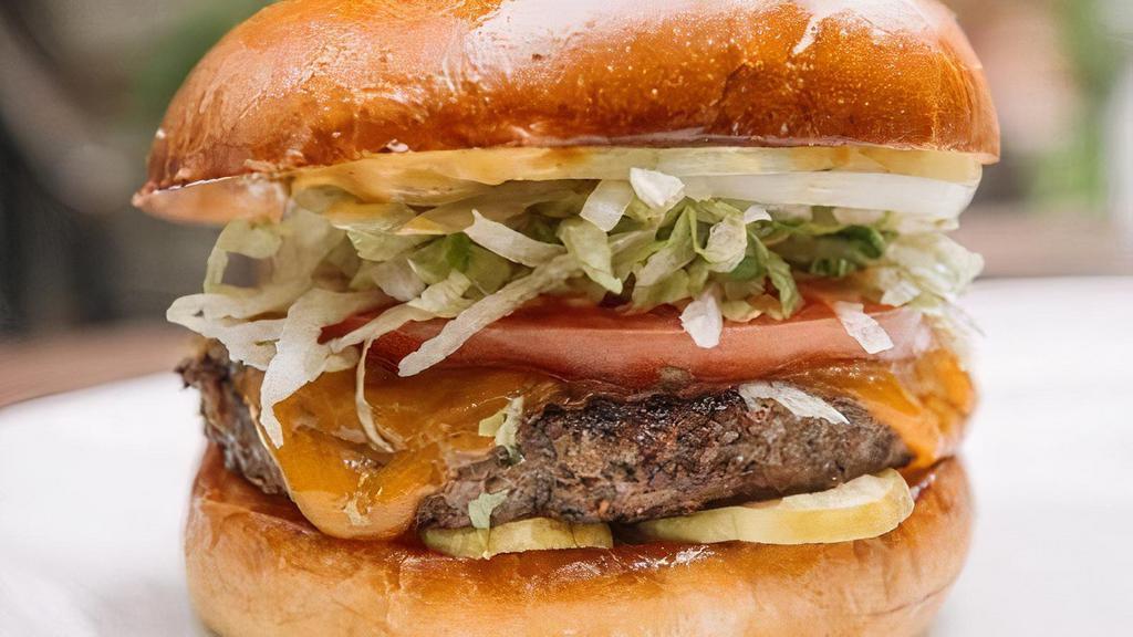 The Backyard Burger · all-natural kansas city kobe beef, yellow cheddar, creamy mustard, shaved sweet onions, dill pickles, shredded lettuce & tomato