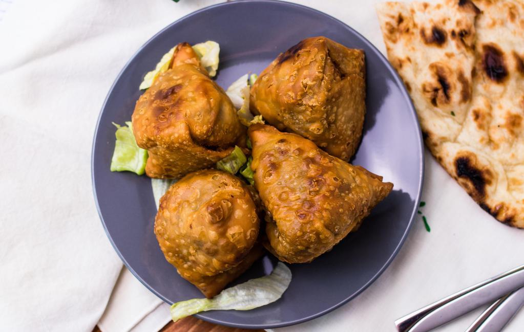 Vegetable Samosas · Two crisp patties filled with potatoes and peas, mildly spiced and deep fried.