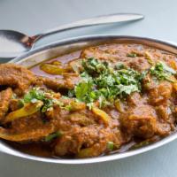 Karahai Lamb · Fresh lamb cooked with herbs, Indian spices, onions, tomatoes and Indian spices, tossed in I...