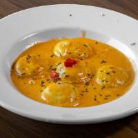 Lobster Ravioli · Ravioli with brandy cream sauce, stuffed with lobster, topped with parmesan cheese and roast...