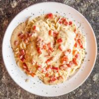 Chicken Tetrazzini · Chicken breast sautéed with a creamy white wine sauce and red peppers.