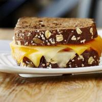 Grilled Cheese · A UNION OF CHEDDAR, AMERICAN AND SWISS CHEESES GARNISHED. WITH PICKLES ON A HEALTHY MULTI-GR...