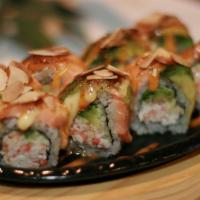Baked Salmon Roll · California Roll Topped with Baked Salmon, Avocado, Almonds, Spicy Mayo & Eel Sauce