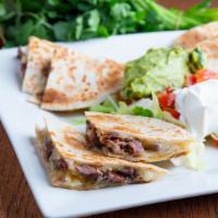 Quesadillas · Four flour tortillas stuffed with beef or chicken fajita, and Monterey Jack cheese. Served w...