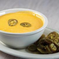 Chile Con Queso · 12 oz size. Add ground beef, chicken or beef fajita for an additional charge.